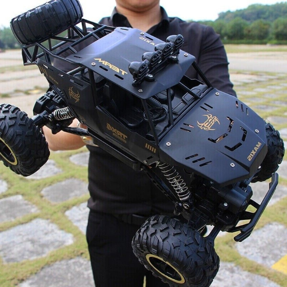 I YAN 4WD RC rock crawler truck with LED headlights, featuring rugged design and two batteries for extended play.