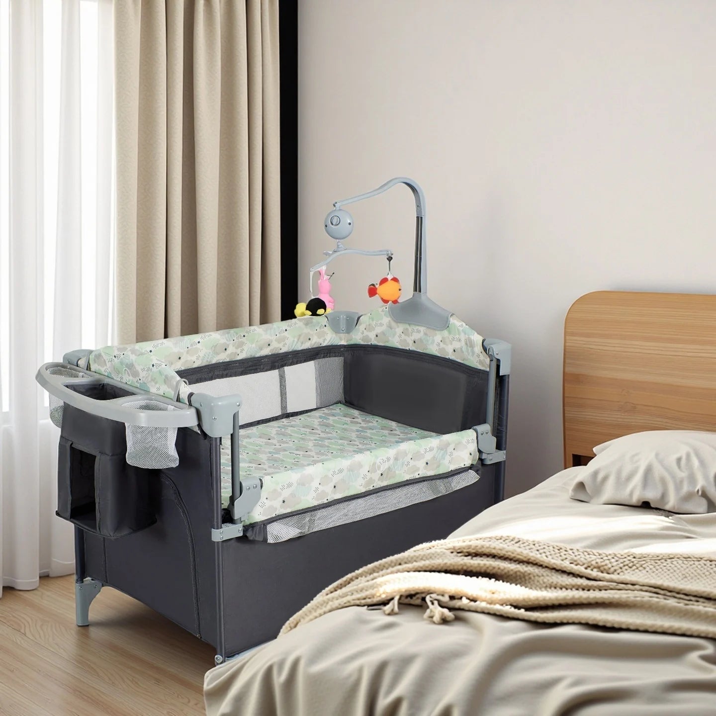I YAN Pack n Play with bassinet, changing table, lockable wheels, music box, and foldable playard for infants and toddlers.