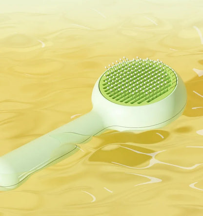 Self-cleaning cat brush and pet hair remover by I YAN with ergonomic handle and stainless steel bristles for effective fur removal.
