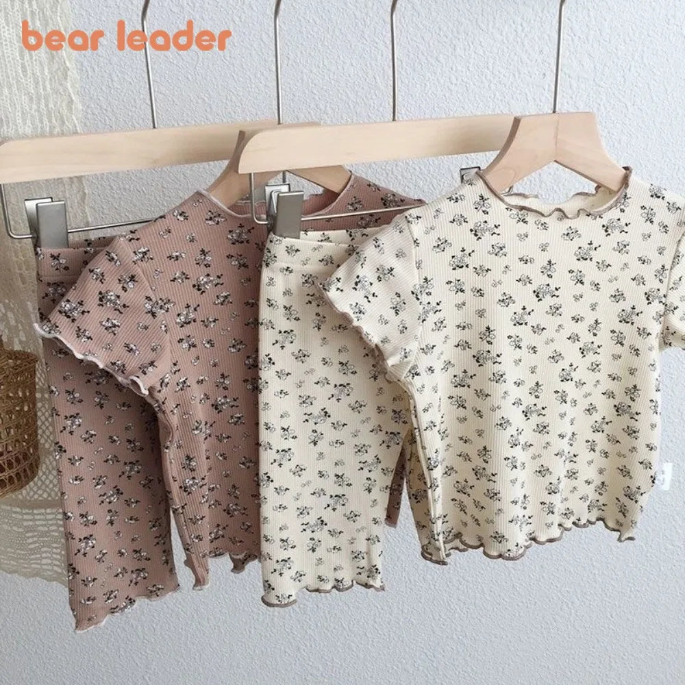 Kids casual summer outfit set by I YAN including a flower printed short sleeve round neck T-shirt and matching pants.