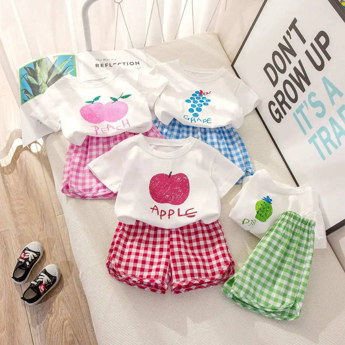 Children's summer 2-piece set by I YAN with a short-sleeved round neck top, plaid shorts, featuring fruit and cartoon lemon and grape designs.