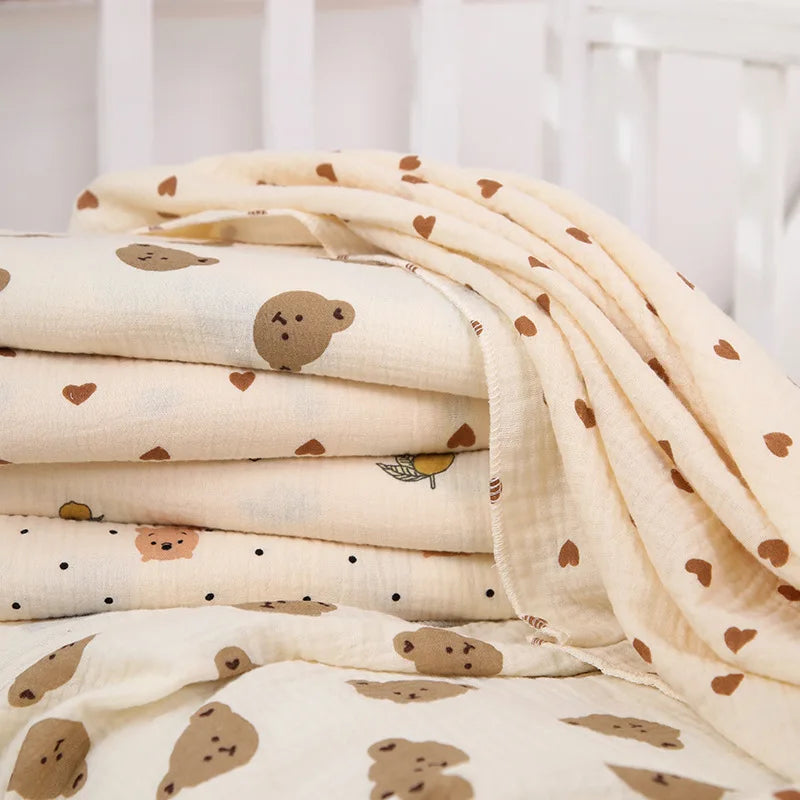 Soft cotton muslin baby swaddle blanket with cute cartoon print from I YAN, breathable and gentle for newborns.