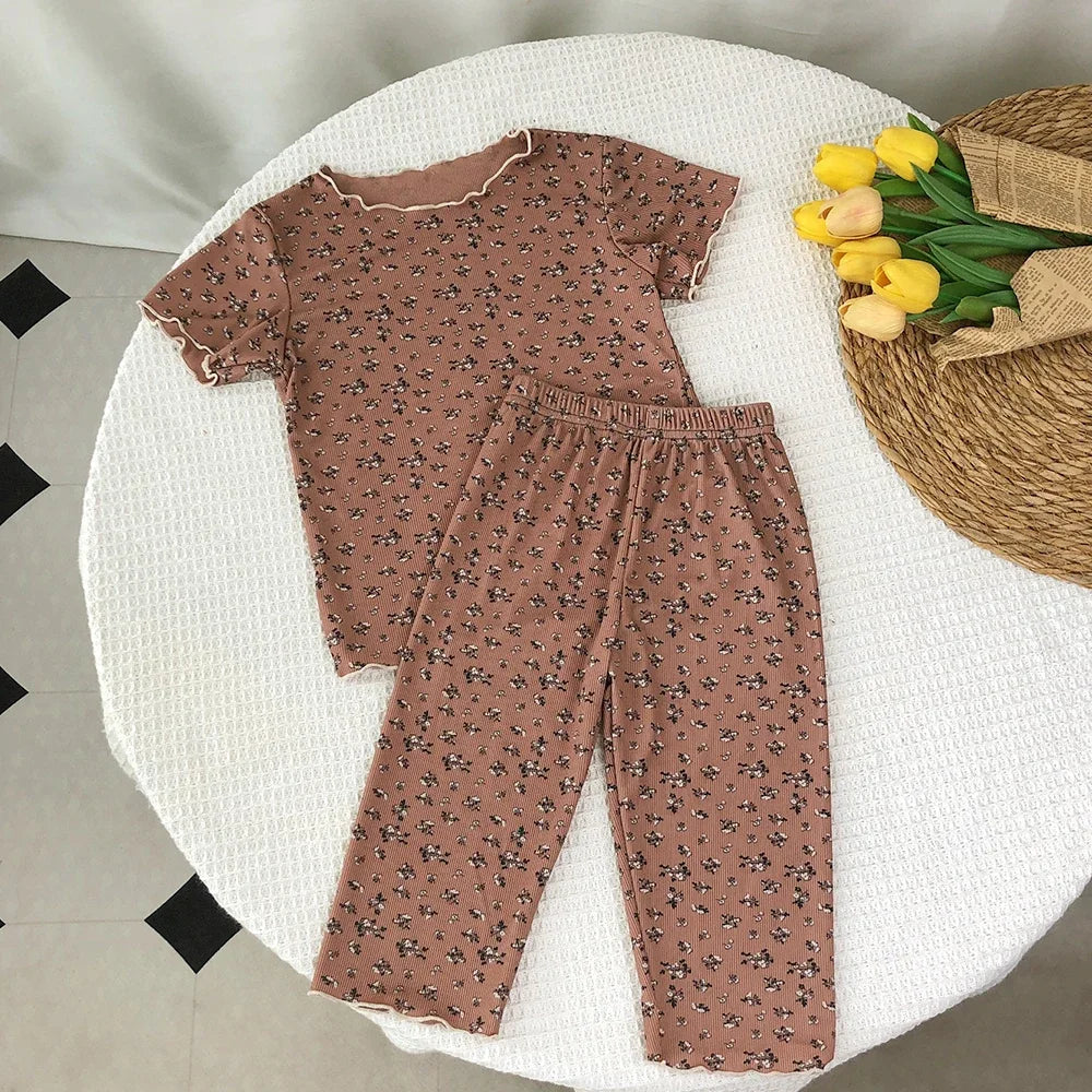 Kids' summer fashion set by I YAN featuring a floral print short sleeve round neck T-shirt and matching pants for casual wear.