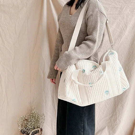 I YAN Mommy Bag Bear maternity diaper bag with stroller straps, multiple compartments, and a portable tote design for travel and organization.