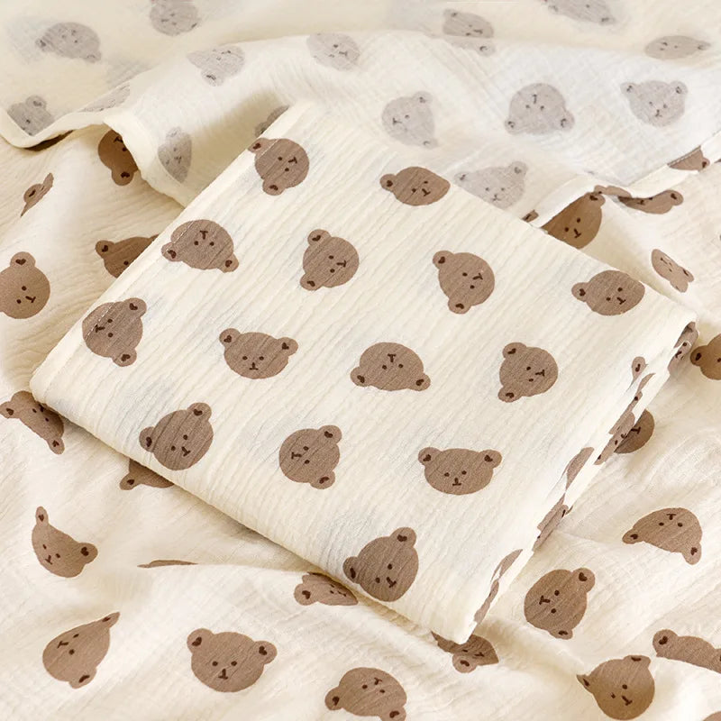 Soft cotton muslin baby swaddle blanket with cute cartoon print from I YAN, breathable and gentle for newborns and infants.
