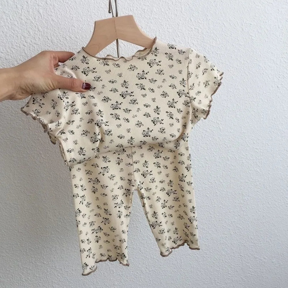 Kids summer casual clothing set by I YAN, featuring a flower-printed short sleeve T-shirt and matching pants for boys and girls.