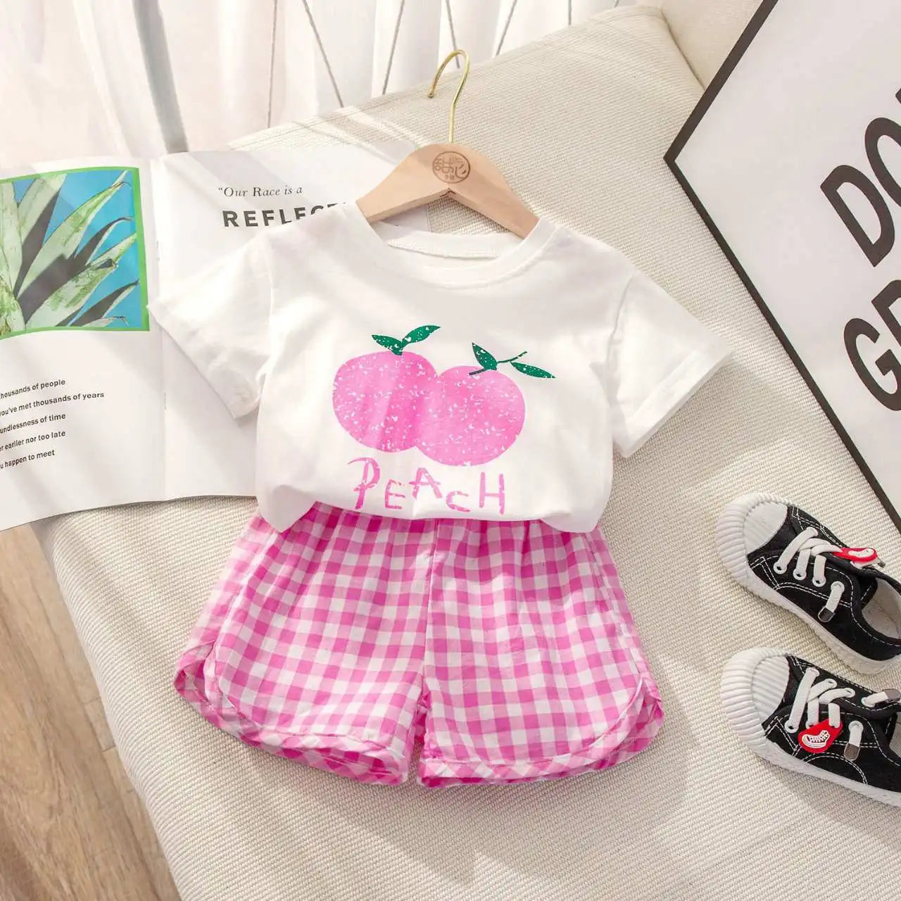 Children's 2-piece summer set by I YAN with short-sleeved round neck top and plaid shorts featuring lemon and grape cartoon prints.