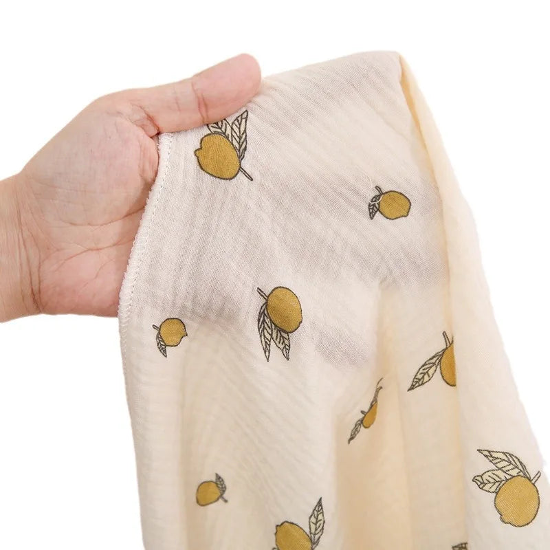 Soft cotton muslin baby swaddle blanket with cute cartoon print, breathable and gentle for newborns by I YAN.