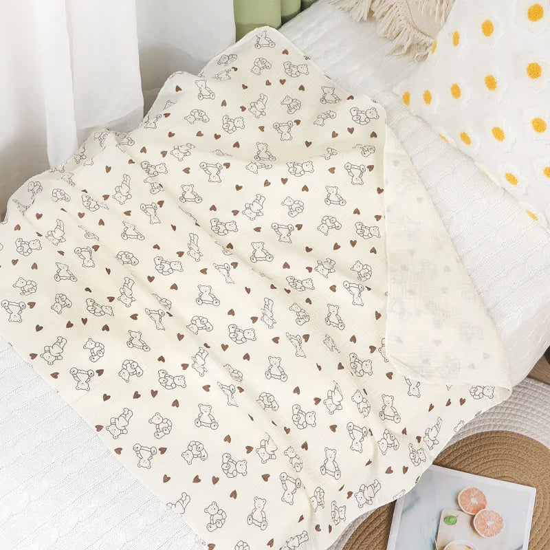 Soft cotton muslin baby swaddle blanket with cute cartoon prints, breathable and gentle for newborns by I YAN.