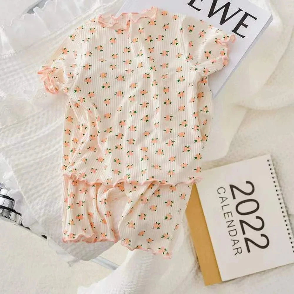 Kids summer casual outfit by I YAN featuring a flower-print short sleeve round neck T-shirt and matching pants set.