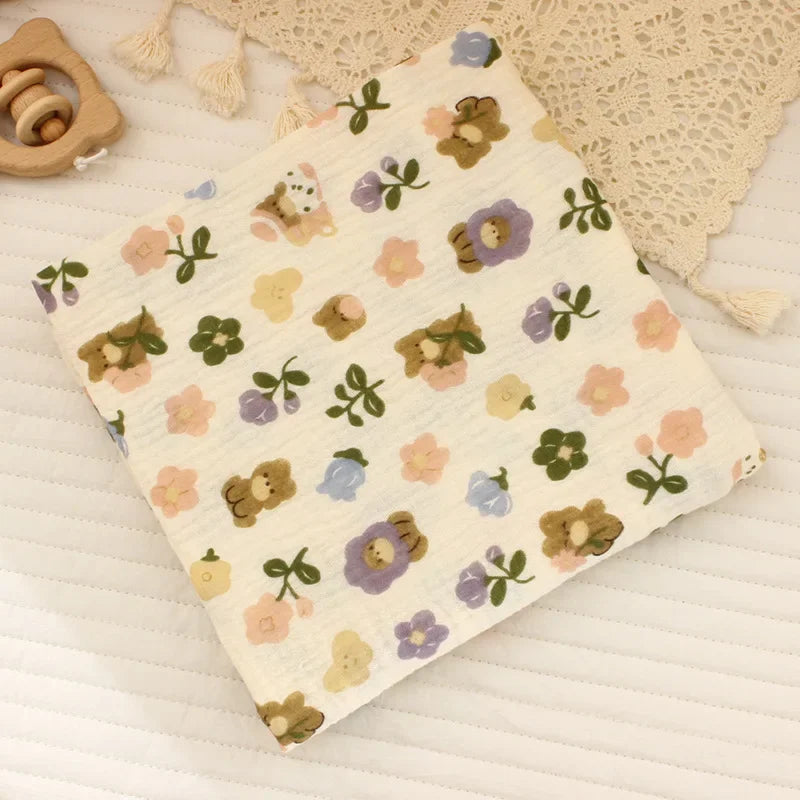 Soft cotton muslin baby swaddle blanket with cute cartoon print, breathable and gentle for newborns by I YAN.