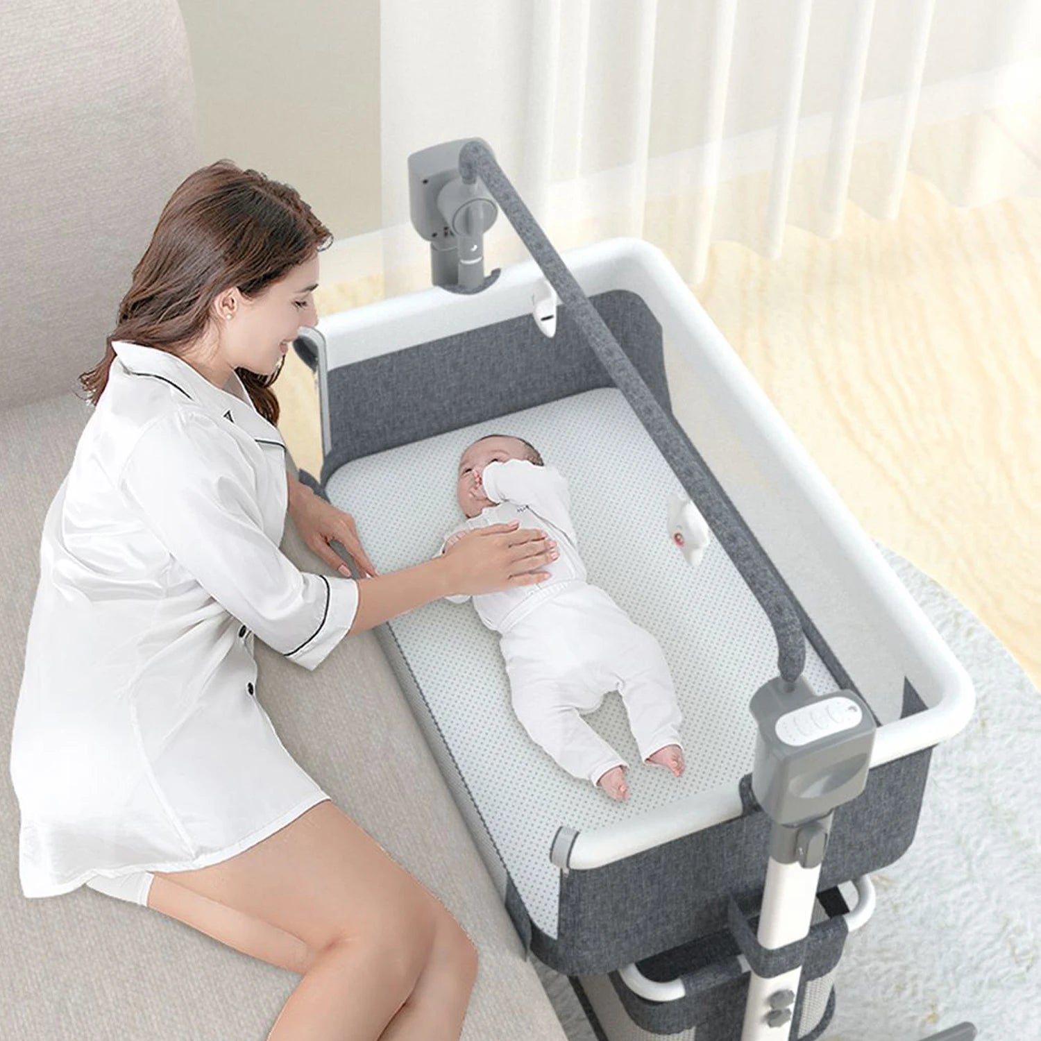 I YAN baby bassinet with remote-controlled electric rocking, foldable newborn bedside co-sleeper for infant comfort and travel.