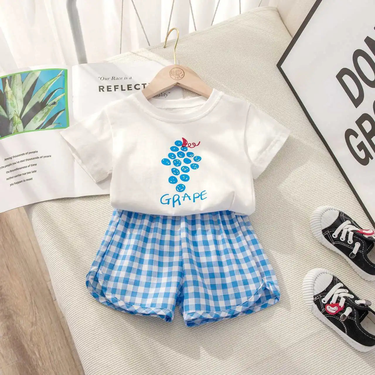 Children's casual summer set by I YAN featuring a short-sleeved round neck top with lemon and grape cartoon print and plaid shorts.