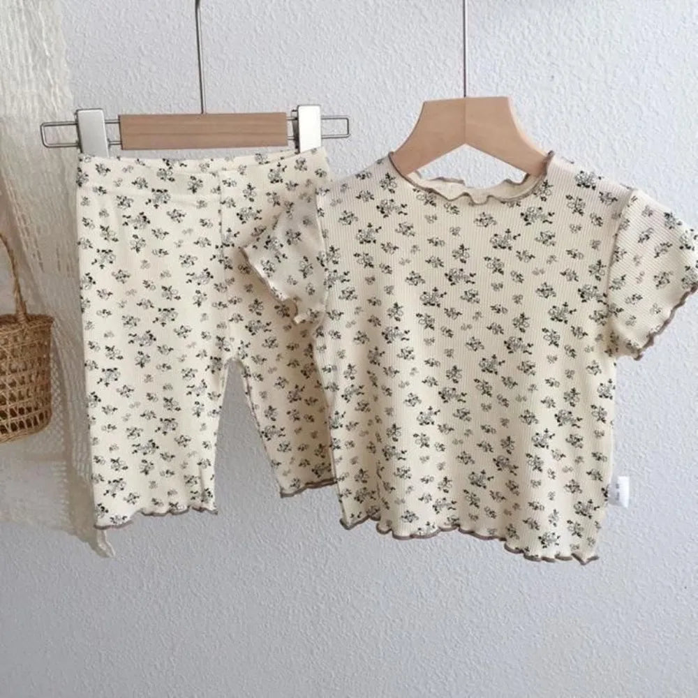 Kids summer casual set by I YAN featuring a flower-printed short sleeve round neck T-shirt and matching pants.