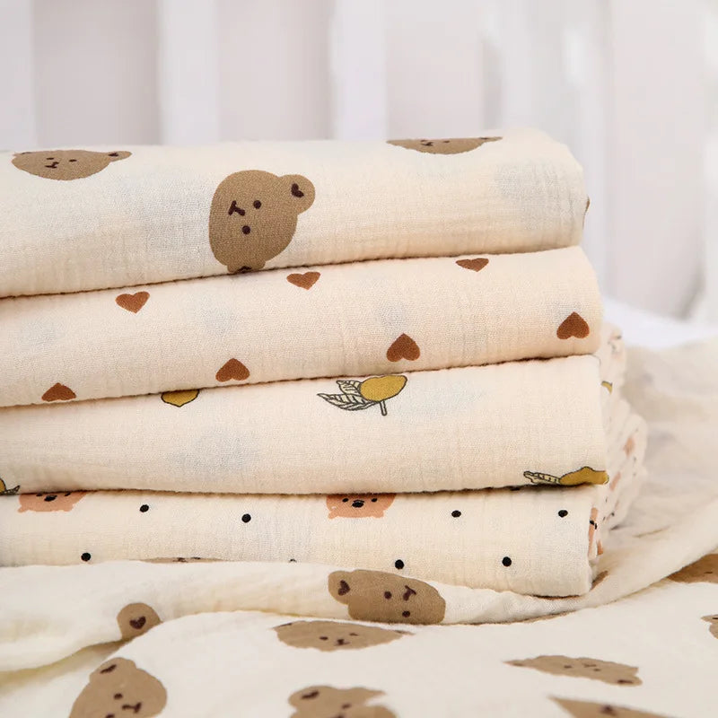 Cotton muslin baby swaddle blanket with cute cartoon print from I YAN, soft and breathable for newborns and infants.