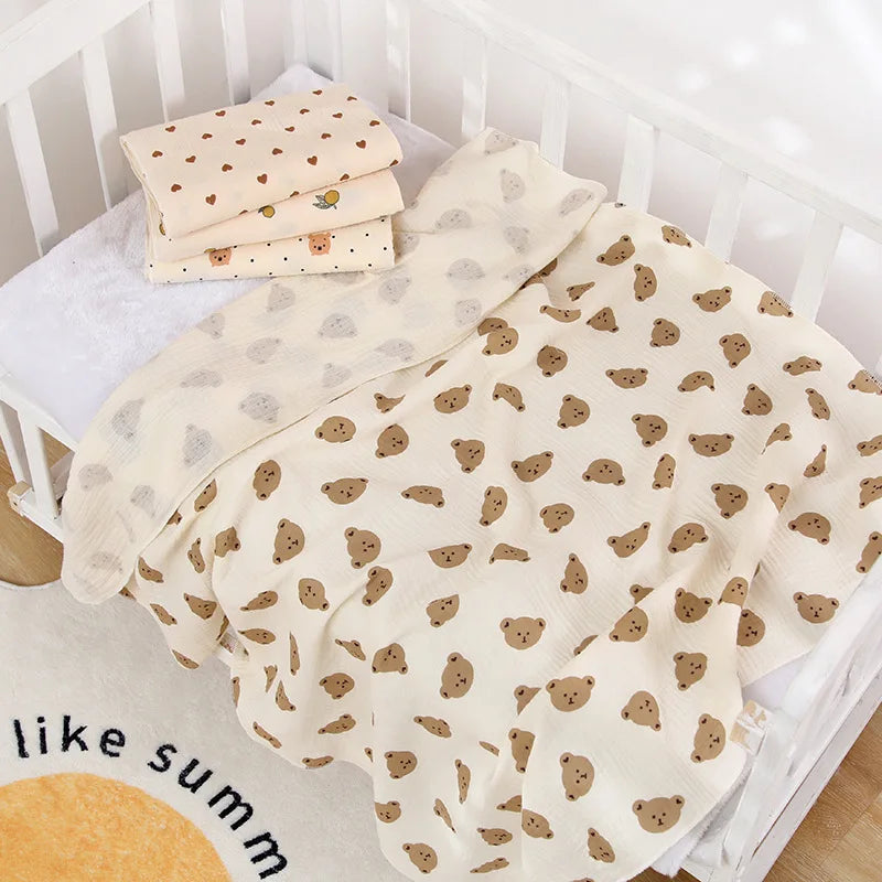 Soft cotton muslin baby swaddle blanket with cute cartoon print by I YAN, breathable and gentle for newborns and infants.