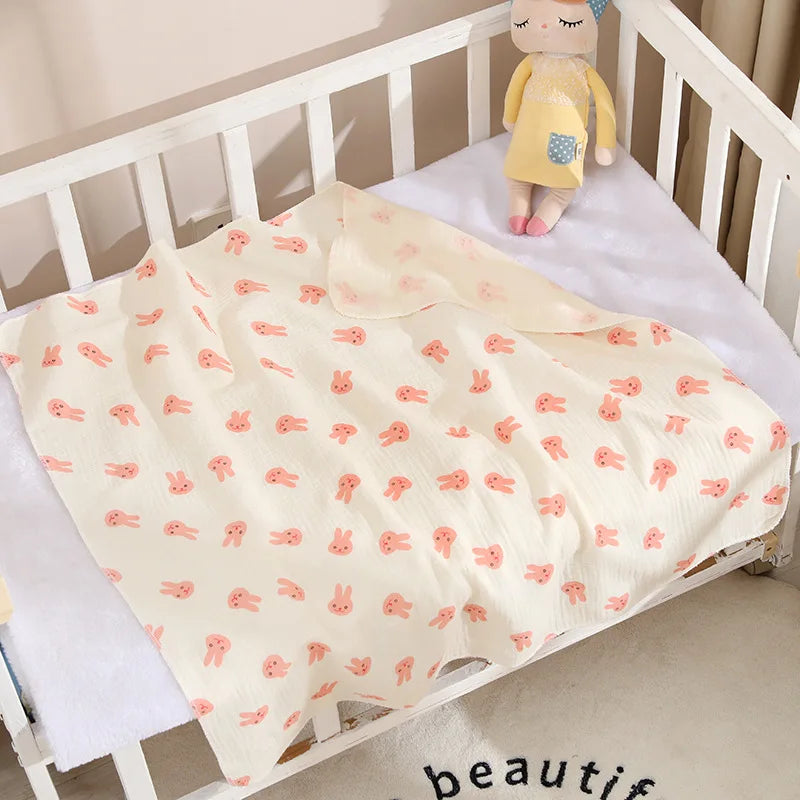 Soft cotton muslin baby swaddle blanket with cute cartoon print, breathable and gentle for newborns by I YAN.